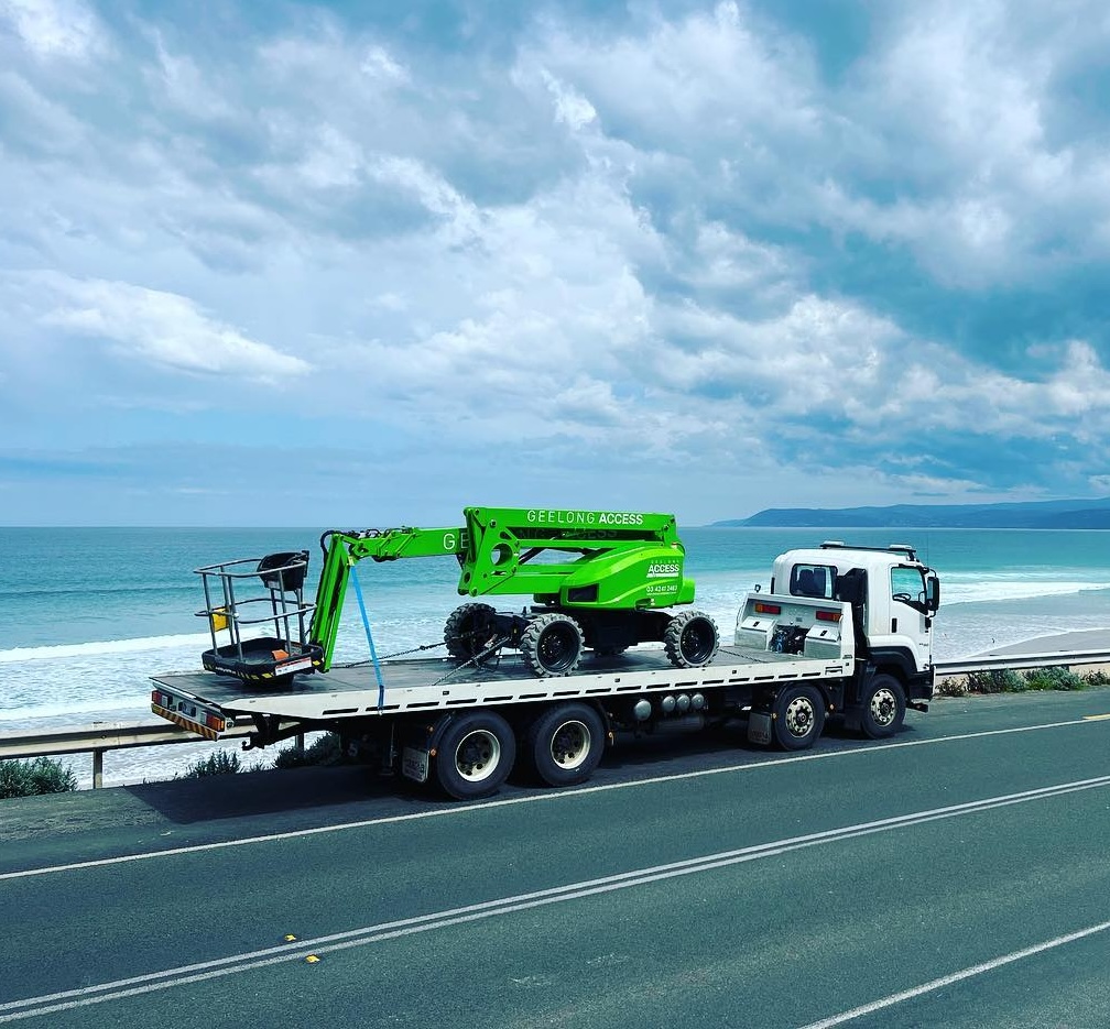 Geelong Access Hire boom lift on a tilt-tray truck along the Surf Coast