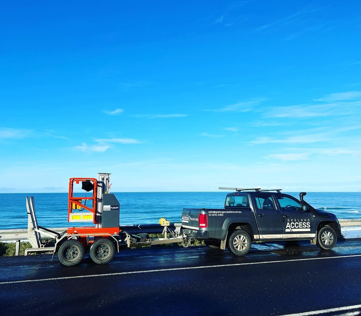Geelong Access Hire ute towing a compact vertical lift along the Surf Coast